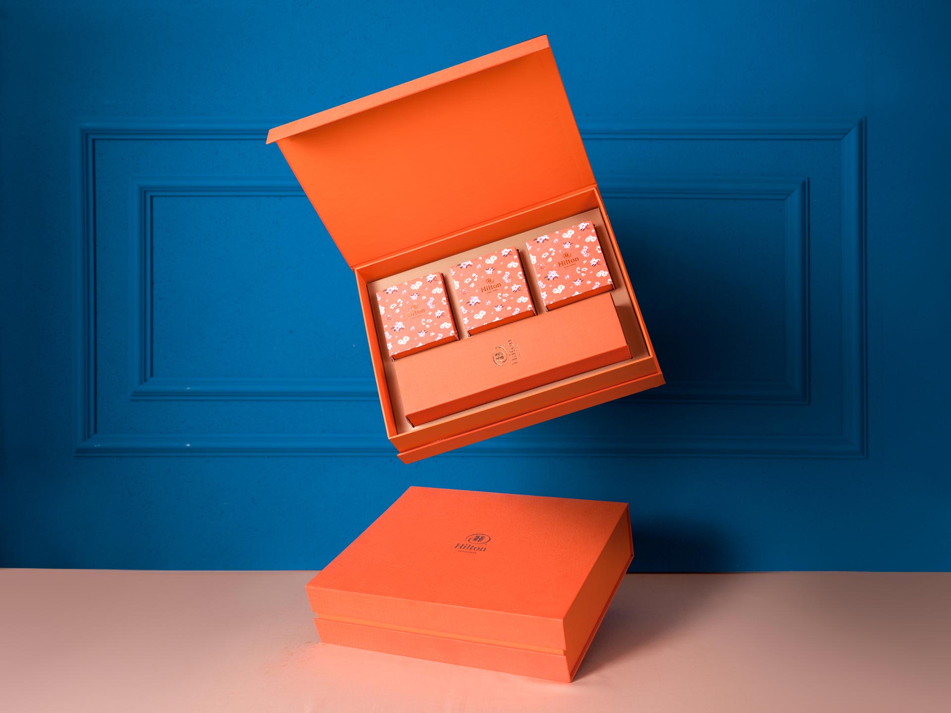 An orange gift box opened to show its compartments